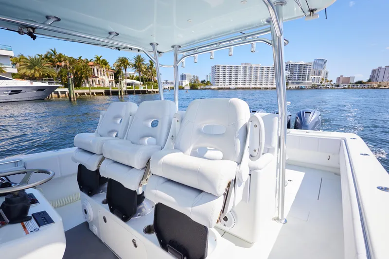  Yacht Photos Pics 2022 Contender 44 Fisharound boat interior with luxurious seating on a sunny waterfront.