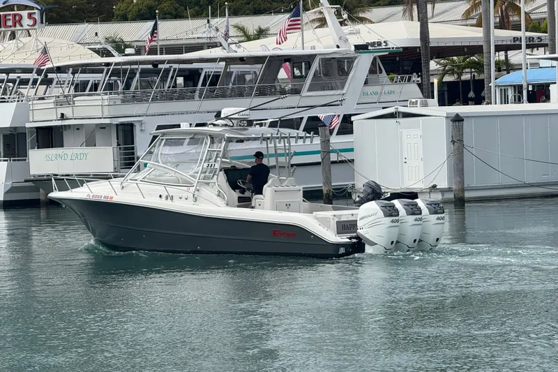  Yacht Photos Pics 2010 Triton 351 Express boat with triple outboard engines in a marina setting.
