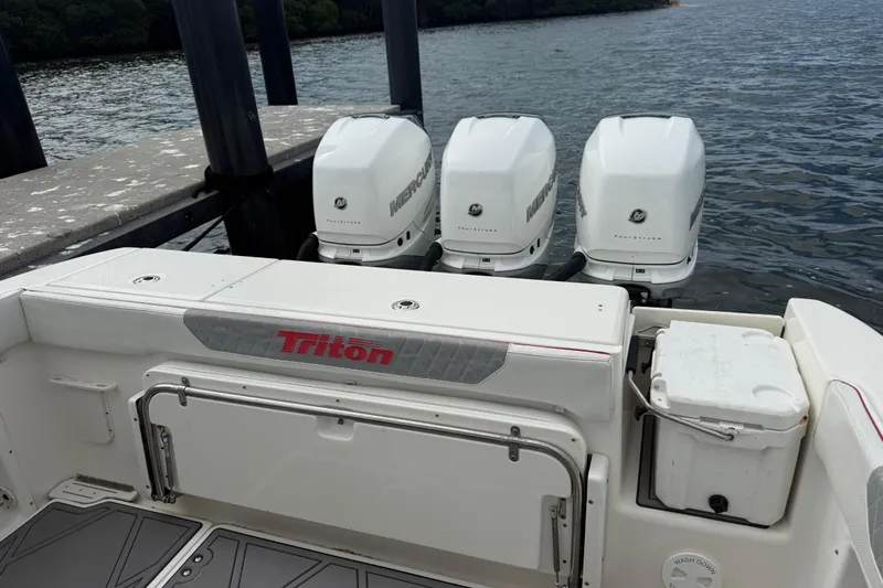  Yacht Photos Pics 2010 Triton 351 Express boat with triple Mercury outboard engines docked by the water.