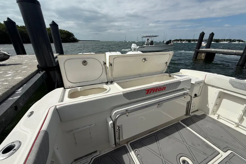  Yacht Photos Pics 2010 Triton 351 Express boat interior at dock, open storage compartments, ocean view.