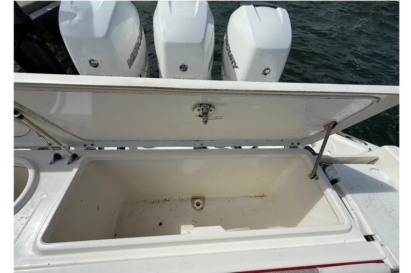  Yacht Photos Pics Open storage compartment on 2010 Triton 351 Express boat with Mercury engines in background.