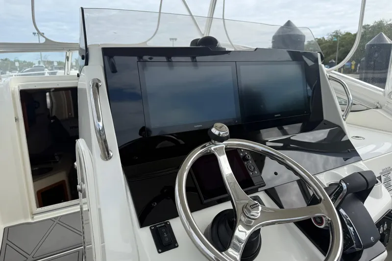  Yacht Photos Pics 2010 Triton 351 Express boat helm with dual Garmin displays and steering wheel.