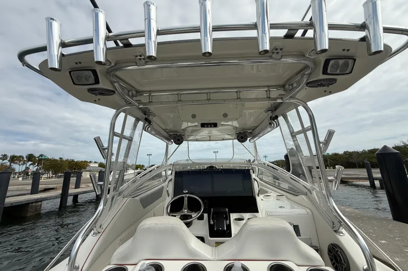  Yacht Photos Pics 2010 Triton 351 Express boat interior with helm, rod holders, and electronics.