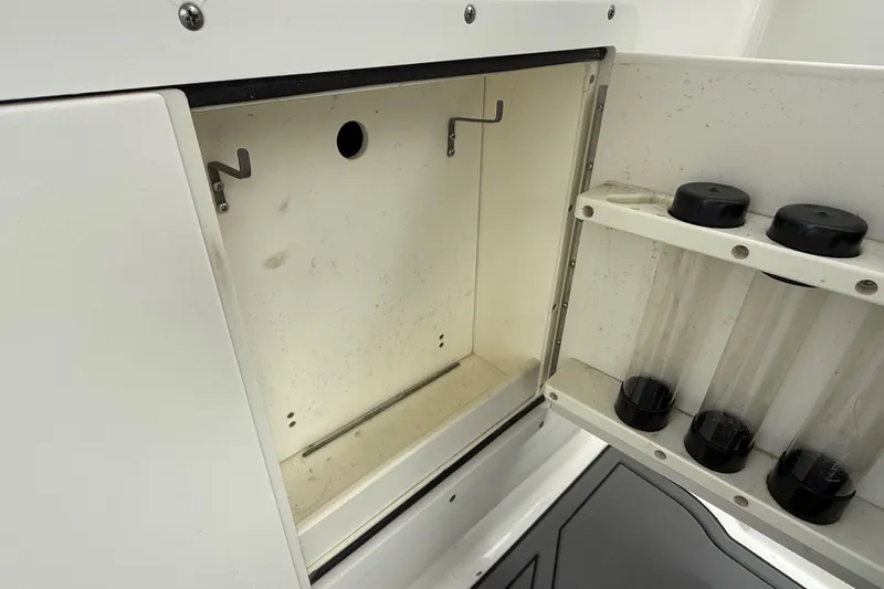  Yacht Photos Pics 2010 Triton 351 Express storage compartment with tube holders and hooks.