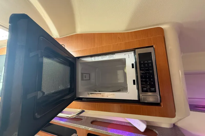  Yacht Photos Pics Open microwave in 2010 Triton 351 Express boat kitchen area.