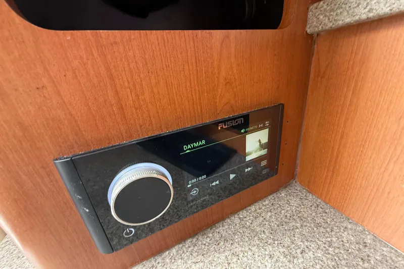  Yacht Photos Pics Fusion audio system in 2010 Triton 351 Express boat, featuring wood paneling.