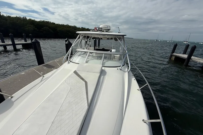  Yacht Photos Pics 2010 Triton 351 Express boat docked by the water on a cloudy day.