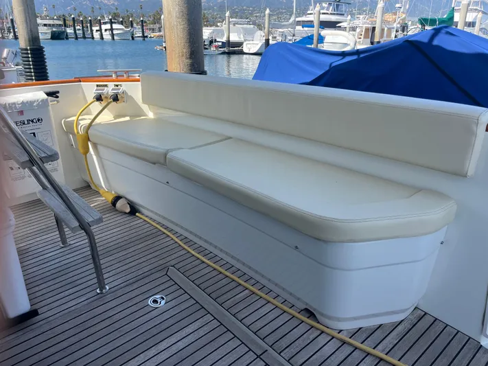 Eleven Seven Yacht Photos Pics 2013 Beneteau Swift Trawler 34 deck with cushioned seating, docked at marina.