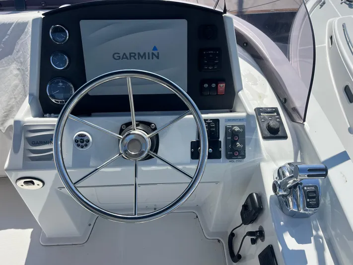 Eleven Seven Yacht Photos Pics Steering console of 2013 Beneteau Swift Trawler 34 with Garmin navigation system.