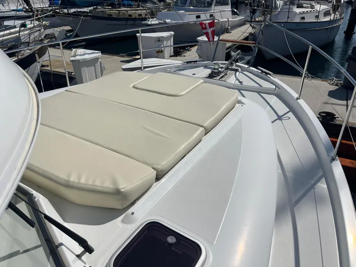 Eleven Seven Yacht Photos Pics 2013 Beneteau Swift Trawler 34 with sunpad on deck, docked at marina.