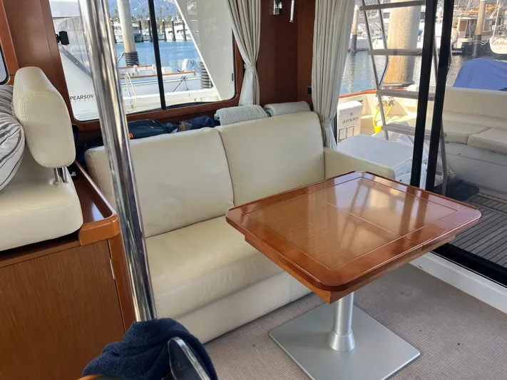 Eleven Seven Yacht Photos Pics Interior of 2013 Beneteau Swift Trawler 34 with sofa and wooden table.
