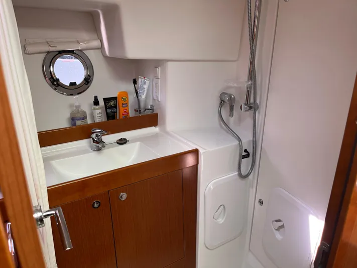 Eleven Seven Yacht Photos Pics Bathroom of 2013 Beneteau Swift Trawler 34 with sink, shower, and porthole.