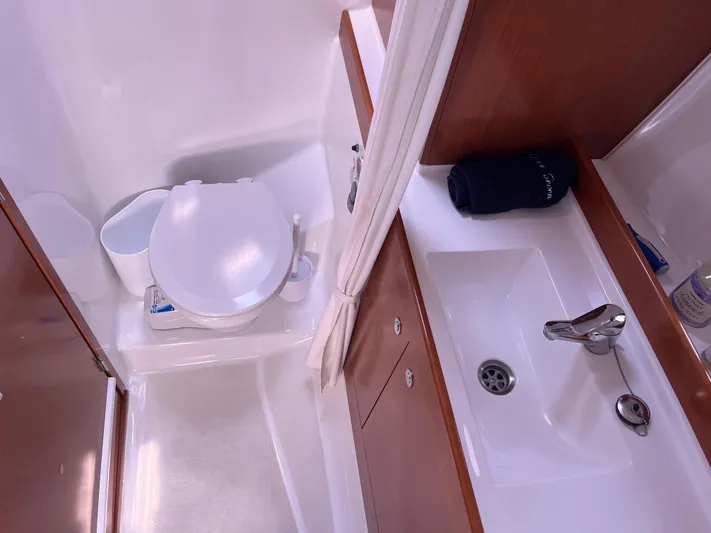 Eleven Seven Yacht Photos Pics 2013 Beneteau Swift Trawler 34 bathroom with toilet and sink, featuring wood accents.