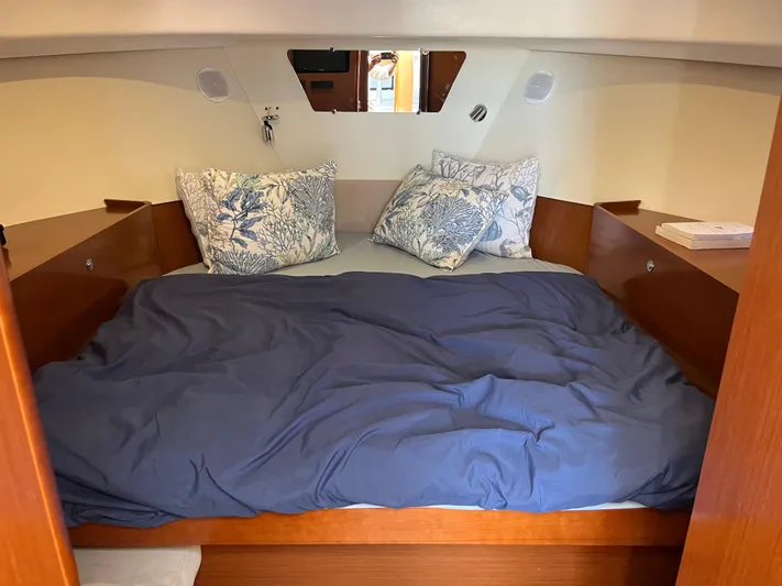 Eleven Seven Yacht Photos Pics Cozy cabin bed in 2013 Beneteau Swift Trawler 34 with blue bedding and floral pillows.