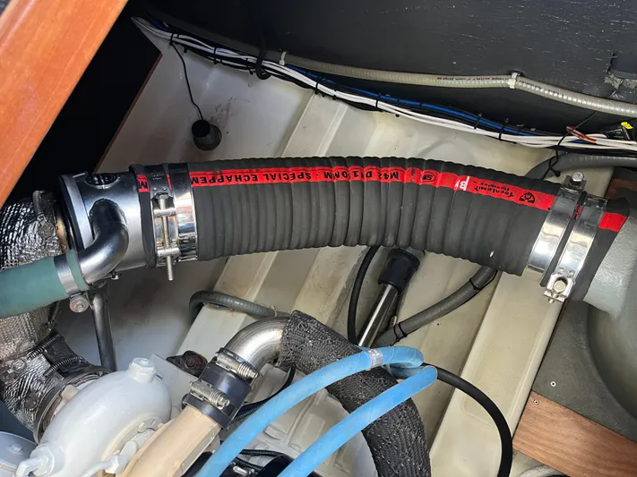 Eleven Seven Yacht Photos Pics Engine compartment of 2013 Beneteau Swift Trawler 34, showing hoses and fittings.