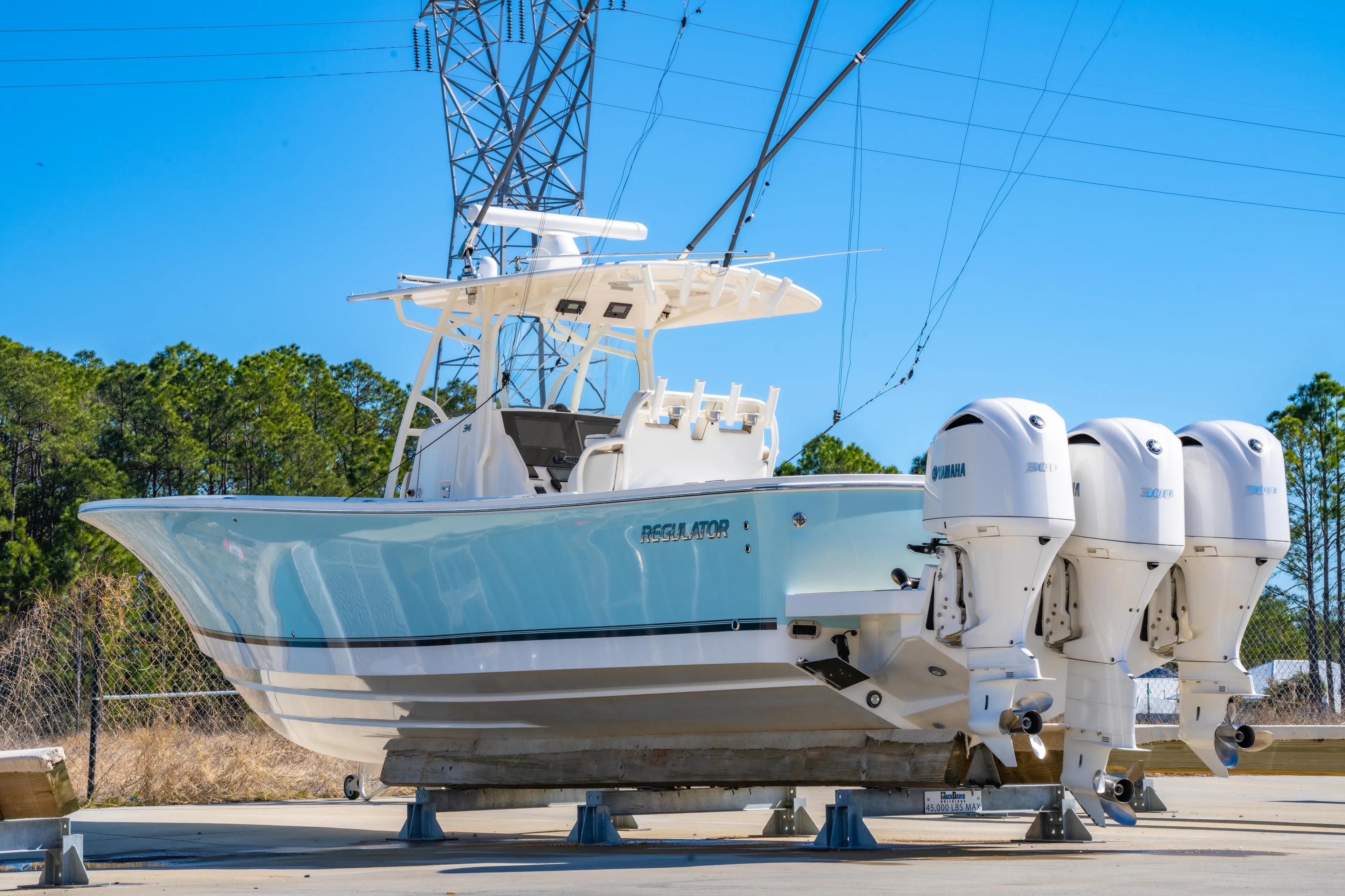  Yacht Photos Pics 2019 Regulator 34 boat with triple Yamaha engines on a sunny day.