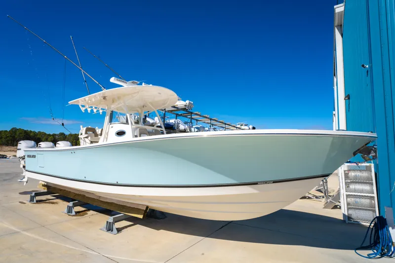 Yacht Photos Pics 2019 Regulator 34 boat on display, light blue hull, clear sky background.