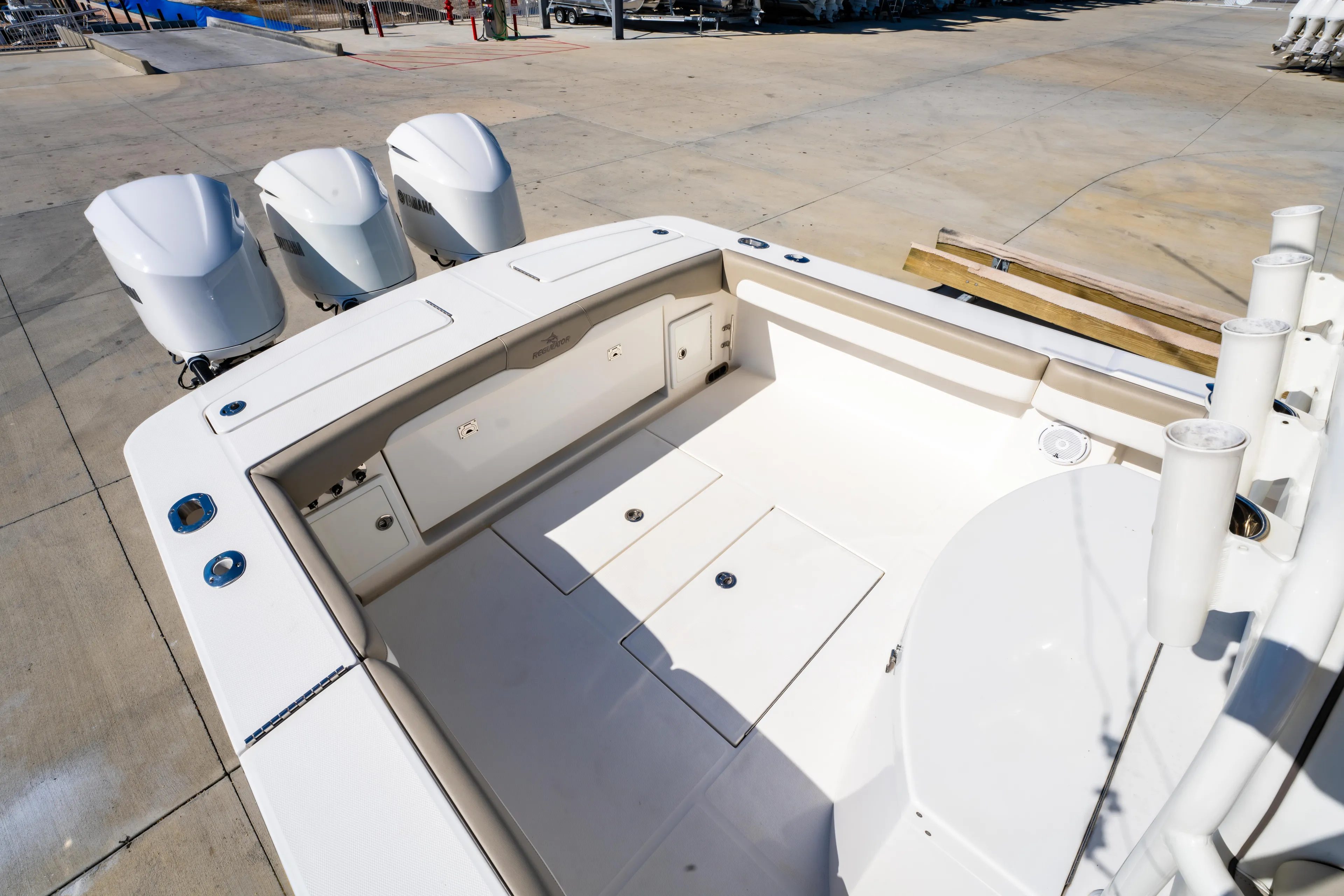  Yacht Photos Pics 2019 Regulator 34 boat deck with triple outboard engines, spacious layout, and storage compartments.