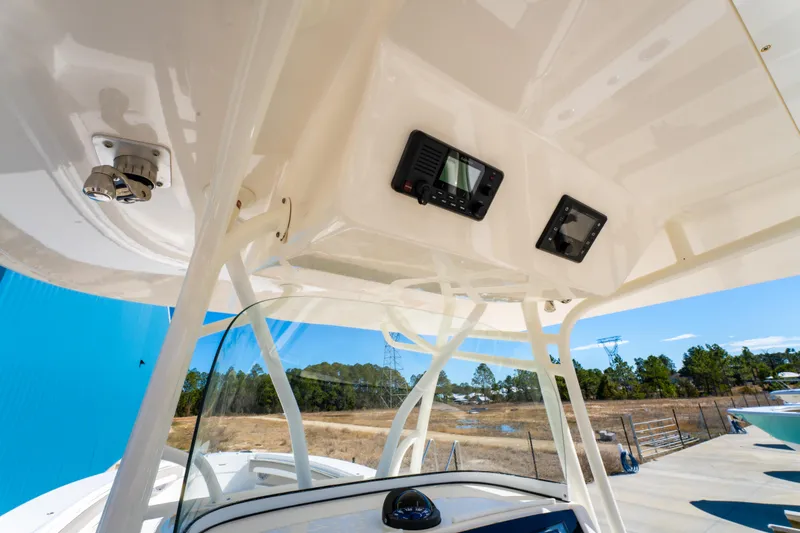  Yacht Photos Pics 2019 Regulator 34 boat console with electronics, white structure, and clear blue sky background.