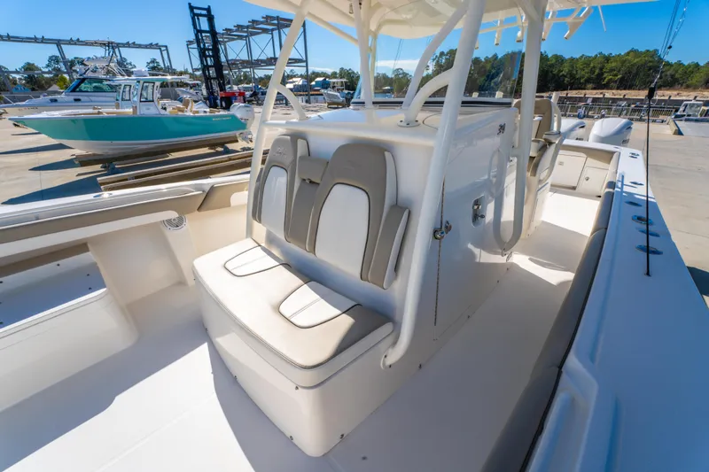  Yacht Photos Pics 2019 Regulator 34 boat interior with cushioned seating and console, docked outdoors.