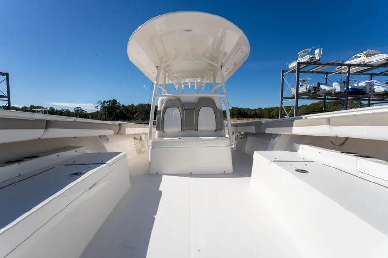  Yacht Photos Pics 2019 Regulator 34 boat interior with seating and storage, under clear blue sky.