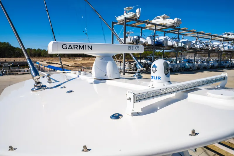  Yacht Photos Pics 2019 Regulator 34 boat with Garmin and FLIR equipment on deck, docked under clear blue sky.