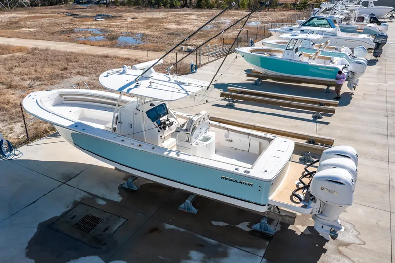  Yacht Photos Pics 2019 Regulator 34 boat with dual engines, docked on a concrete platform.