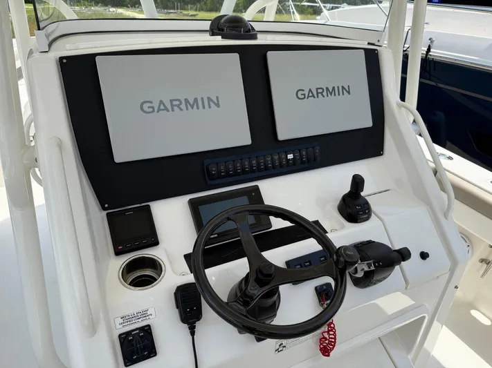  Yacht Photos Pics 2019 Regulator 34 boat helm with dual Garmin displays and steering wheel.
