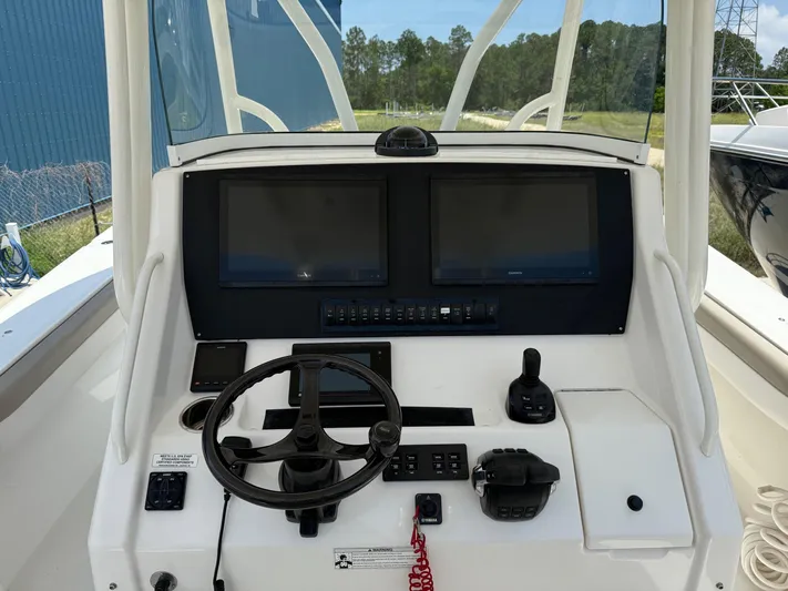  Yacht Photos Pics Control console of a 2019 Regulator 34 boat with dual screens and steering wheel.