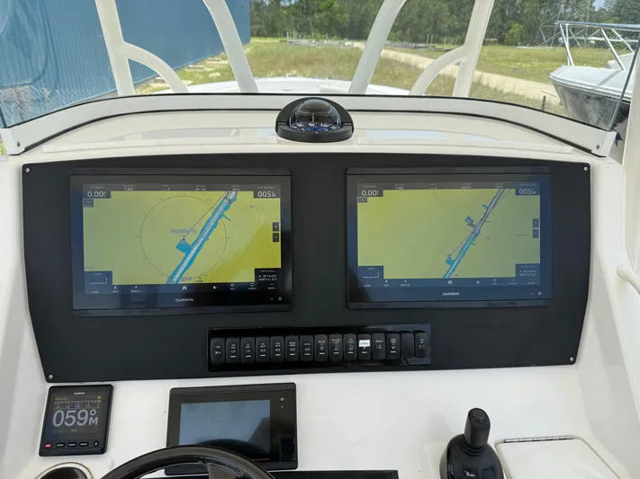  Yacht Photos Pics Control panel of a 2019 Regulator 34 boat with dual navigation screens.