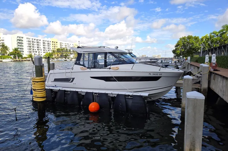  Yacht Photos Pics 2021 Jeanneau NC 895 docked at marina with scenic waterfront view.