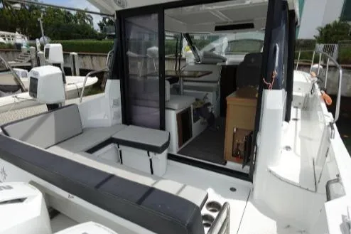  Yacht Photos Pics 2021 Jeanneau NC 895 boat interior with seating and helm station.