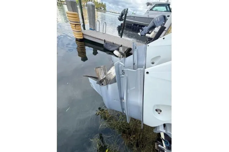  Yacht Photos Pics 2021 Jeanneau NC 895 boat docked, showing outboard motor and propeller.