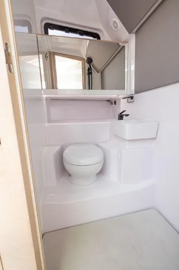  Yacht Photos Pics 2024 Axopar 45 XC Cross Cabin BRABUS Trim bathroom with modern fixtures and sleek design.