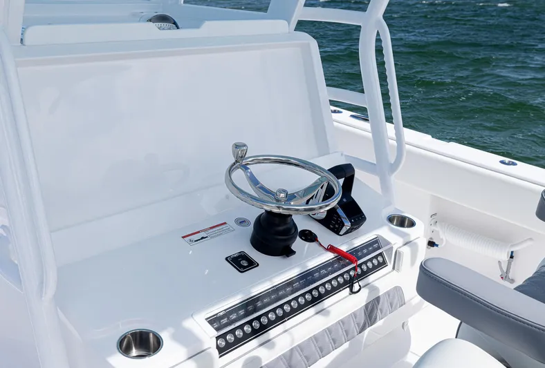  Yacht Photos Pics 2025 Invincible 35 Catamaran helm with steering wheel and controls, ocean backdrop.