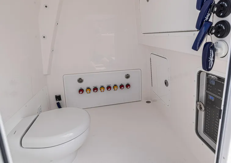  Yacht Photos Pics 2025 Invincible 35 Catamaran interior with toilet and control panel.