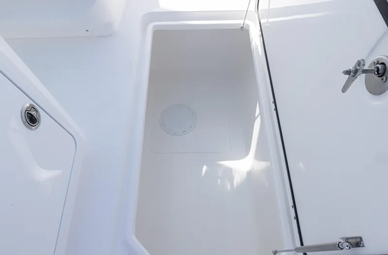  Yacht Photos Pics Invincible 35 Catamaran 2025 interior storage compartment, white finish, open hatch.