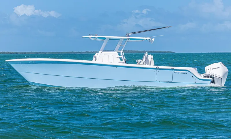  Yacht Photos Pics 2025 Invincible 35 Catamaran cruising on blue ocean waters.