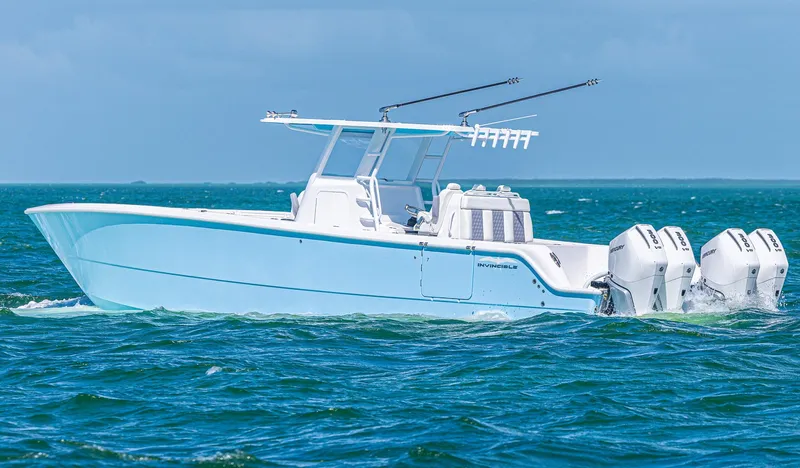  Yacht Photos Pics 2025 Invincible 35 Catamaran cruising on open water with triple outboard engines.