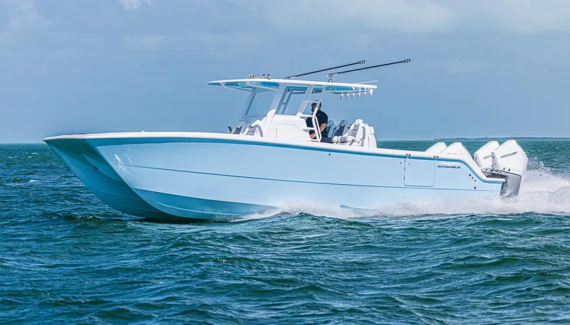  Yacht Photos Pics 2025 Invincible 35 Catamaran cruising on open water, showcasing sleek design and powerful engines.