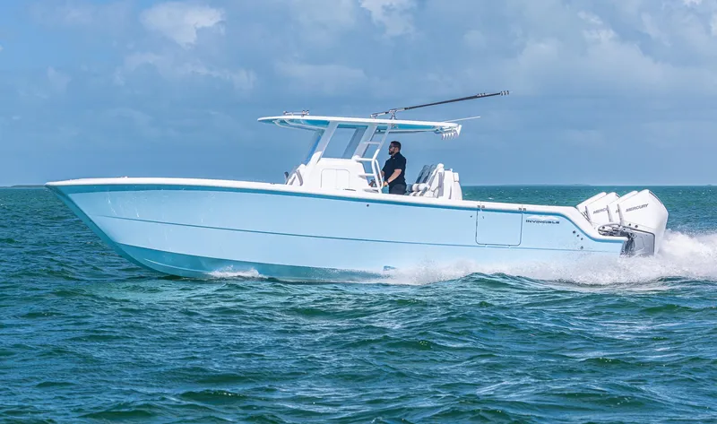  Yacht Photos Pics 2025 Invincible 35 Catamaran cruising on open water under clear skies.