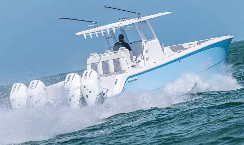  Yacht Photos Pics 2025 Invincible 35 Catamaran speeding on ocean with four powerful engines.