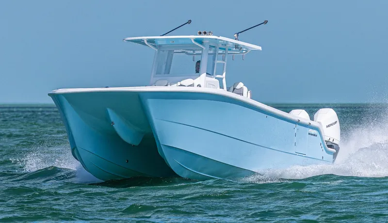  Yacht Photos Pics 2025 Invincible 35 Catamaran cruising on open water, showcasing sleek design and performance.