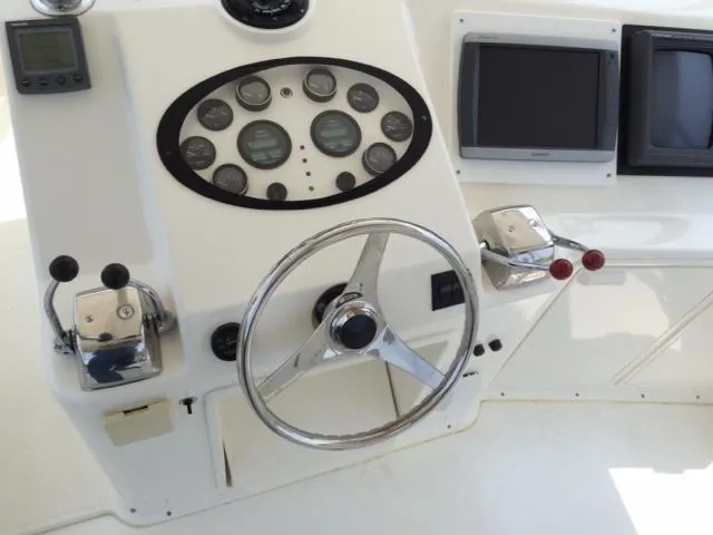 Fryedays Off Yacht Photos Pics Control panel of a 2003 Ocean Yachts 43 Super Sport boat with steering wheel and gauges.