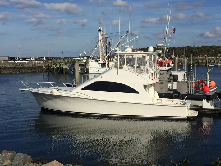 Fryedays Off Yacht Photos Pics 2003 Ocean Yachts 43 Super Sport docked at a marina under a clear sky.