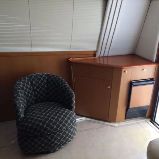 Fryedays Off Yacht Photos Pics Interior of 2003 Ocean Yachts 43 Super Sport with patterned chair and wooden cabinetry.