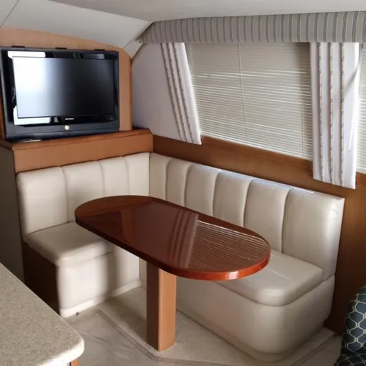 Fryedays Off Yacht Photos Pics Interior of 2003 Ocean Yachts 43 Super Sport with TV, table, and seating.