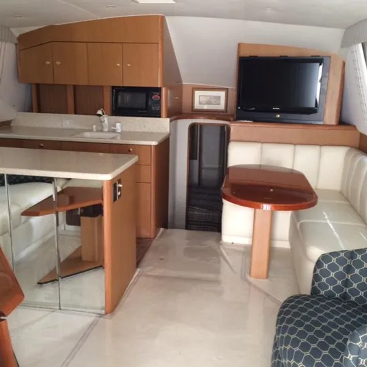 Fryedays Off Yacht Photos Pics Interior of 2003 Ocean Yachts 43 Super Sport with kitchen and seating area.