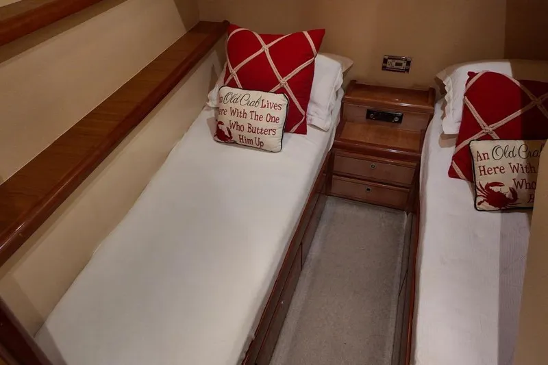  Yacht Photos Pics 2007 Bertram 510 Convertible cabin with twin beds and decorative pillows.