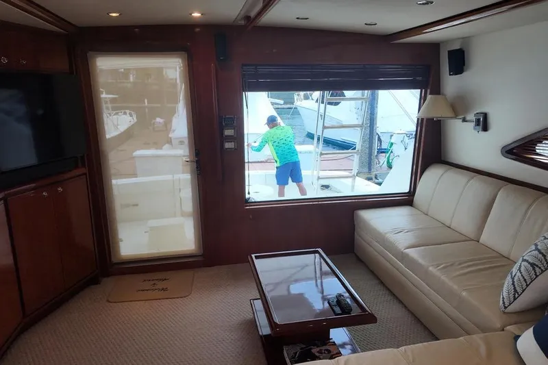  Yacht Photos Pics Luxurious interior of 2007 Bertram 510 Convertible yacht with leather seating and large window view.